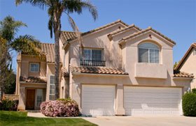 Two story stucco home with red tile roof Two story stucco home with red tile roof